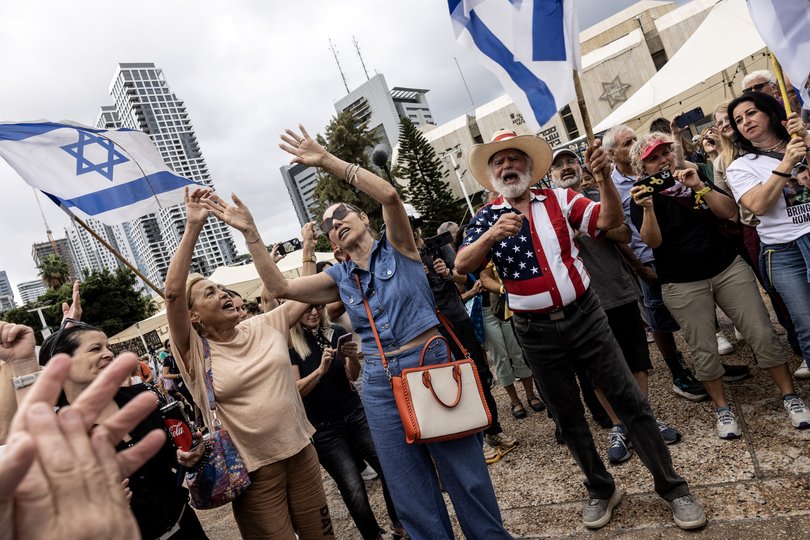 People react to the news of an agreement between Israel and Hamas in "Hostages Square" in Tel Aviv early Thursday.