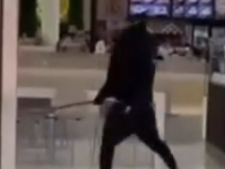 Two males have been filmed swinging machetes at each other in a Melbourne shopping centre. Supplied