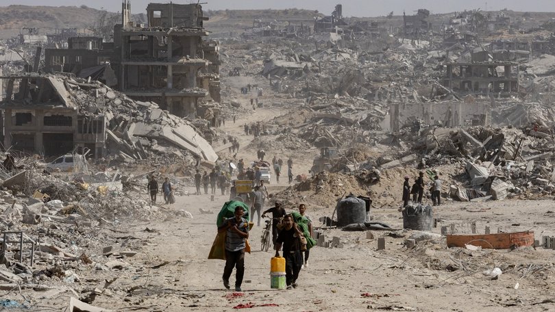 Palestinians return to inspect their destroyed homes in the Tal al-Hawa area, southwest of Gaza City, Oct. 11, 2025.