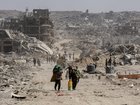 Palestinians return to inspect their destroyed homes in the Tal al-Hawa area, southwest of Gaza City, Oct. 11, 2025.