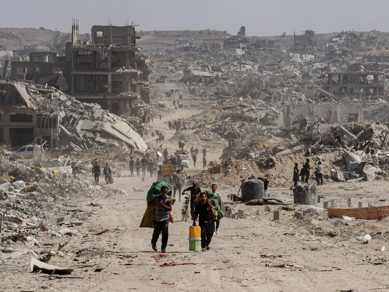 Palestinians return to inspect their destroyed homes in the Tal al-Hawa area, southwest of Gaza City, Oct. 11, 2025.