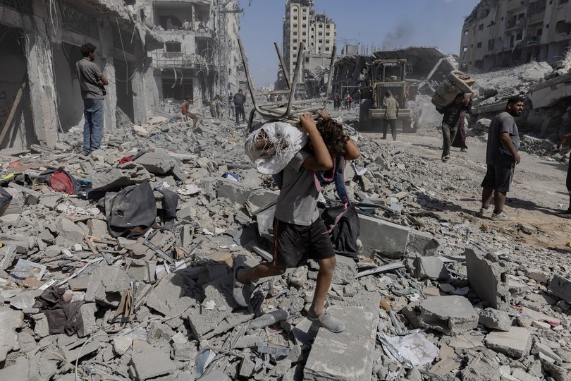 Palestinians return to inspect their destroyed homes in the Tal al-Hawa area, southwest of Gaza City, Oct. 11, 2025.