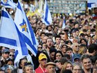 People wait for the first of the hostages to be released in Tel Aviv, Israel. 