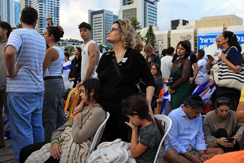 TEL AVIV - OCTOBER 13: People react as they watch the hostage release live stream at Hostages Square on October 13, 2025 in Tel Aviv, Israel. The ceasefire deal between Israel and Hamas has brought an end to the two years of war that followed the attacks of Oct. 7, 2023. A condition of the deal was the immediate return of 48 hostages held in Gaza, around 20 of whom were believed to be alive. (Photo by Chris McGrath/Getty Images)