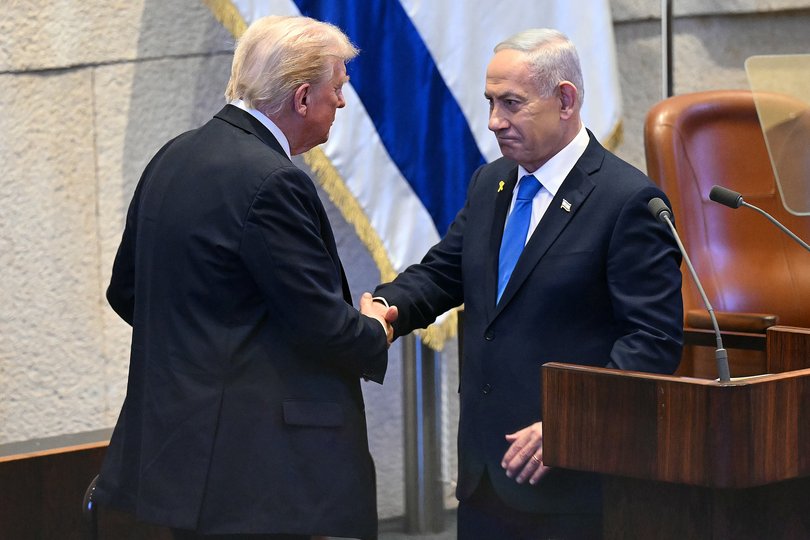 U.S. President Donald Trump shakes hands with Israeli Prime Minister Benjamin Netanyahu at the Israeli parliament, the Knesset, on October 13, 2025 in Jerusalem.