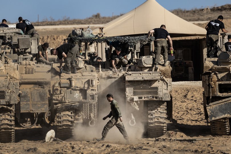 Israeli soldiers, tanks and armored vehicles at a staging area near the border with the Gaza Strip, in Israel, Oct.11, 2025. 