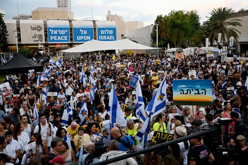 People wait for the start of the hostage release live stream at Hostages Square on October 13, 2025 in Tel Aviv, Israel. 