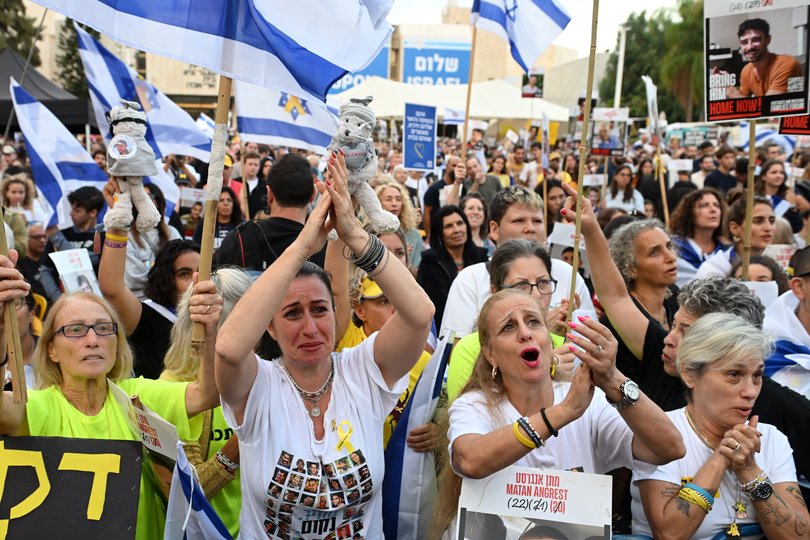 People react as they wait for the start of the hostage release live stream at Hostages Square on October 13, 2025 in Tel Aviv, Israel. 