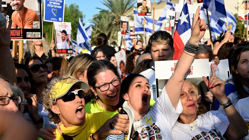 People react as they watch the hostage release live stream at Hostages Square on October 13, 2025 in Tel Aviv, Israel.