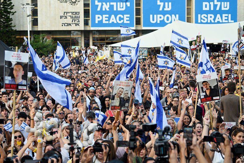 People gather to watch the hostage release live stream at Hostages Square on October 13, 2025 in Tel Aviv, Israel.