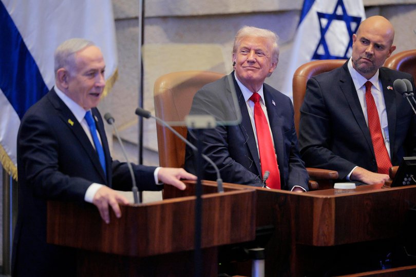 Israeli Prime Minister Benjamin Netanyahu addresses the Knesset as U.S. President Donald Trump and Amir Ohana, Speaker of the Israeli Knesset, look on October 13, 2025 in Jerusalem.