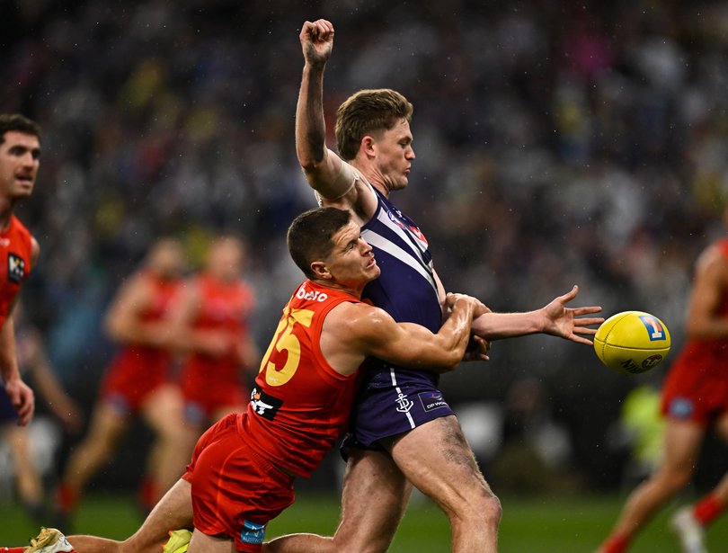 PERTH, AUSTRALIA - SEPTEMBER 06: Nathan O'Driscoll of the Dockers is tackled by Connor Budarick of the Suns during the AFL Second Elimination Final match between the Fremantle Dockers and the Gold Coast Suns at Optus Stadium on September 06, 2025 in Perth, Australia. (Photo by Daniel Carson/AFL Photos)