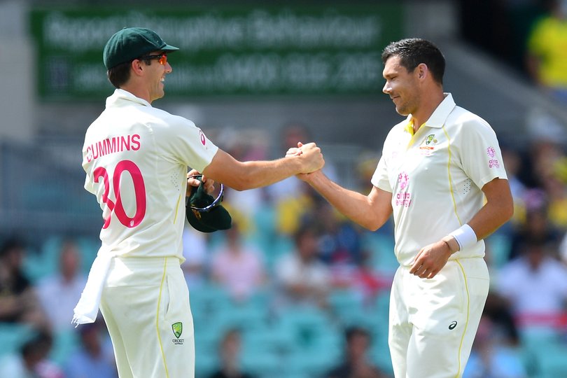 Scott Boland is congratulated by Pat Cummins after taking the wicket of Stuart Broad.