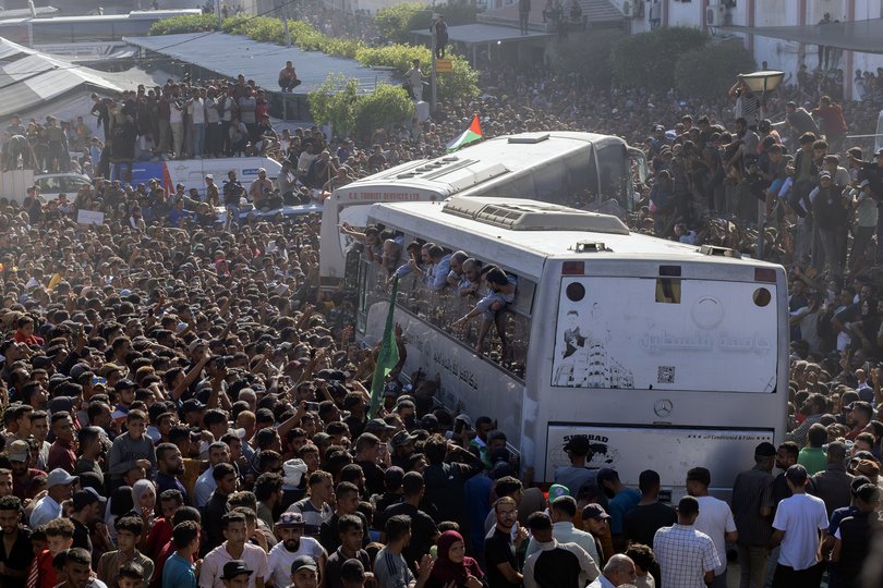 A cheering throng greets Palestinian prisoners released by Israel.