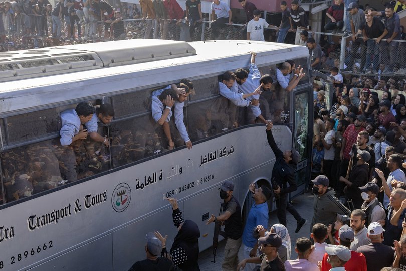A cheering throng greets Palestinian prisoners released by Israel as they arrive at Nasser Hospital.