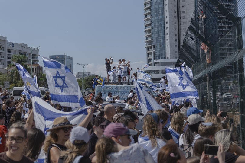 Crowds gather as a helicopter carrying hostages freed from captivity by Hamas in Gaza arrives at Beilinson Hospital in Petah Tikva, Israel.