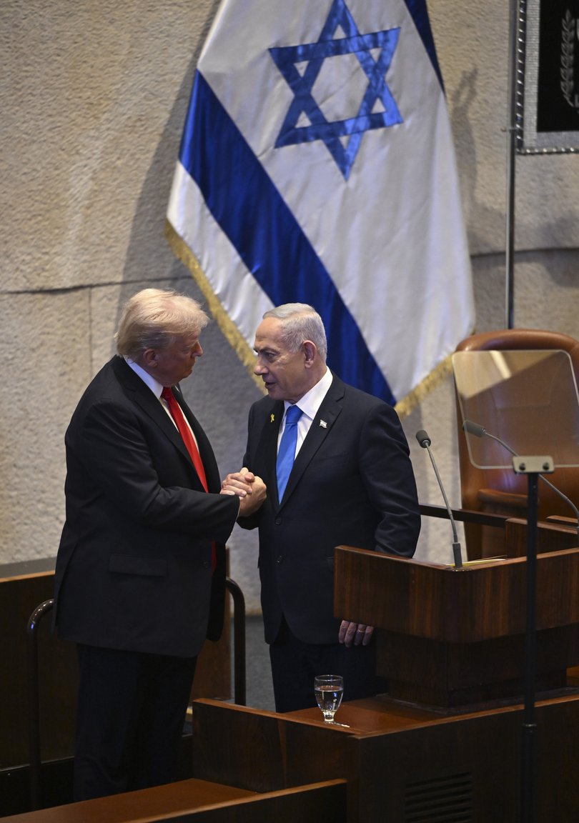 President Donald Trump, left, shakes hands with Prime MInister Benjamin Netanyahu of Israel as he addresses the Knesset, or Israeli parliament, in Jerusalem on Monday, Oct. 13, 2025.