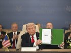US President Donald Trump signs a document during a peace summit in Sharm El-Sheikh, Egypt, on Monday, Oct. 13, 2025. 