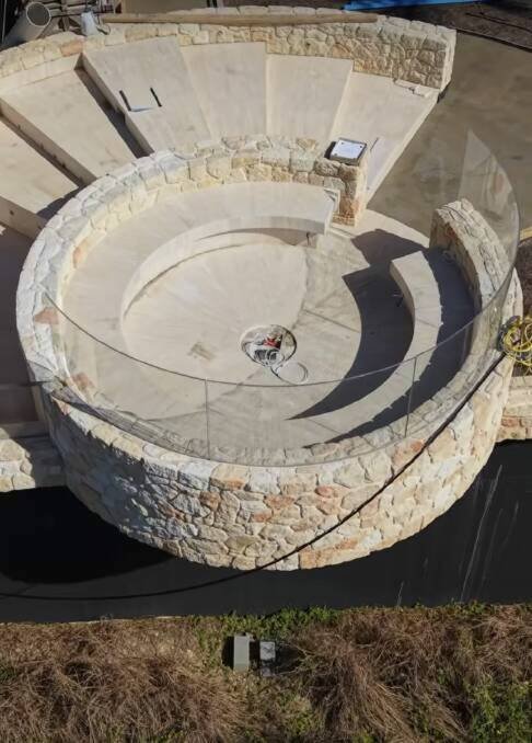 The built-in fire pit cantilevers over the clifftop. Picture J Group Projects/Instagram