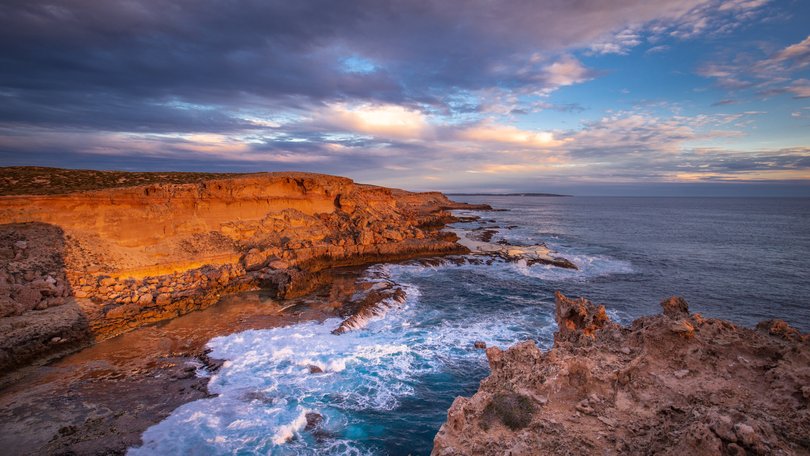 Evening golden sunlight reflecting off the sea cliffs on Dirk Hartog Island, Western Australia