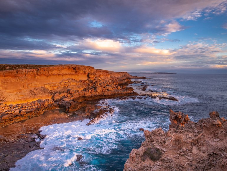 Evening golden sunlight reflecting off the sea cliffs on Dirk Hartog Island, Western Australia