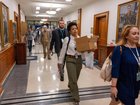 Members of the Pentagon press corp walk out of the Pentagon as a group after turning in their press credentials in Washington. 
