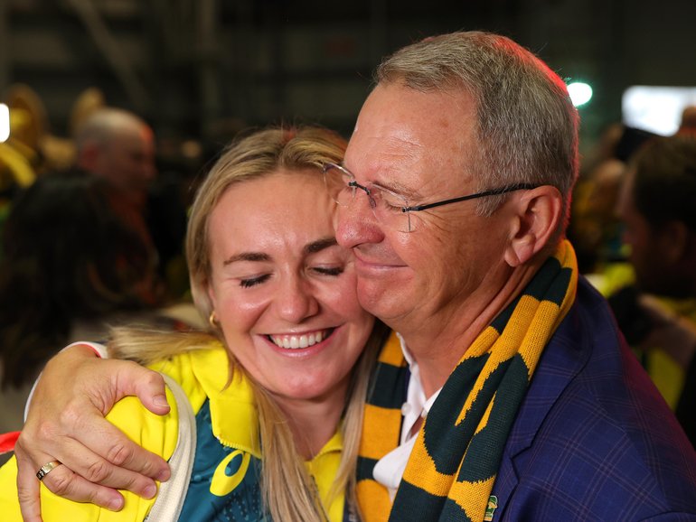 Ariarne Titmus hugs father Steve during the Australian Olympic Games athletes charter flight arrival at Sydney.