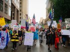 Demonstrators march through the streets of downtown despite heavy rain for the No King Day.