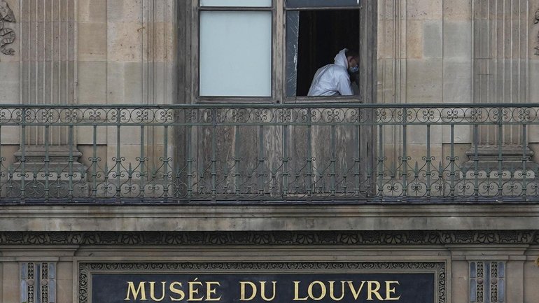 Brazen thieves used a crane to break a window when they robbed jewelry from the Louvre in Paris. (AP PHOTO)