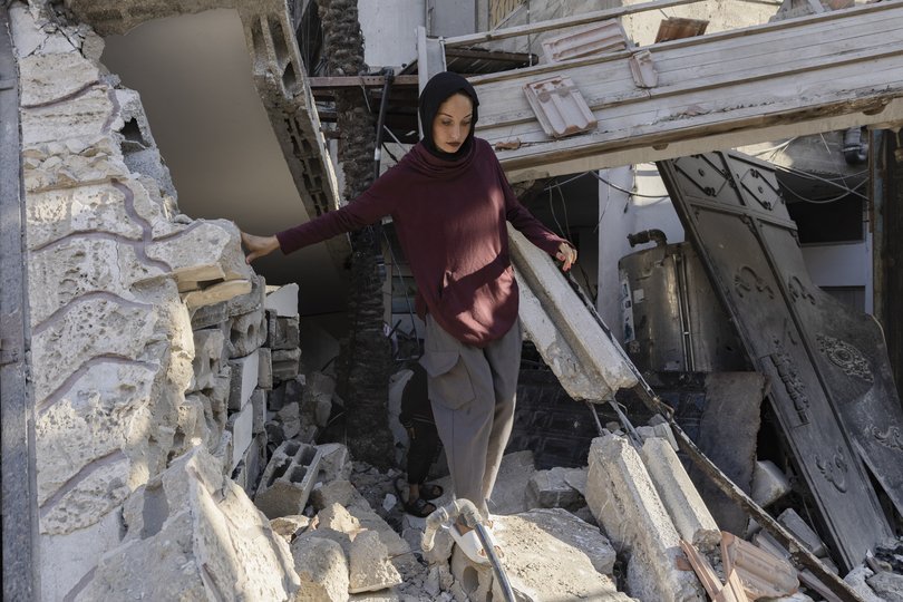 Sabah Abu Ghanem in front of her destroyed house in Gaza City, Gaza Strip.