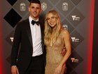 Scott, pictured with wife Alex at the Brownlow Medal, is suing his former manager for taking $2.6 million from his investment accounts.