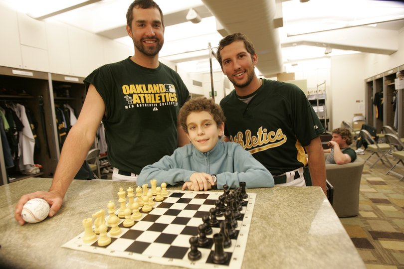 Chess champion Daniel Naroditsky meets Andrew Brown and Huston Street of the Oakland Athletics in the clubhouse before the game against the Minnesota Twins at McAfee Coliseum in Oakland, California on April 23, 2008.