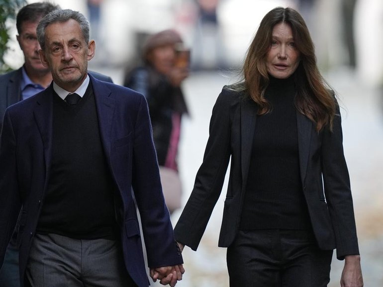 Former French president Nicolas Sarkozy left his home with wife Carla Bruni to attend prison. (AP PHOTO)