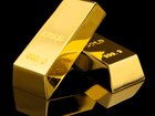 Shiny gold bars on black background. Space for text