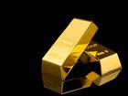 Shiny gold bars on black background. Space for text