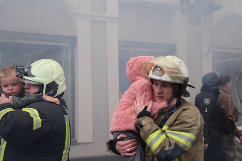 Officials carry the children after the Russian missile attack on Kyiv, Ukraine on October 22, 2025.