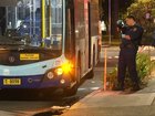 Police taking photos of the exterior of the bus where a man was stabbed early on Thursday morning.