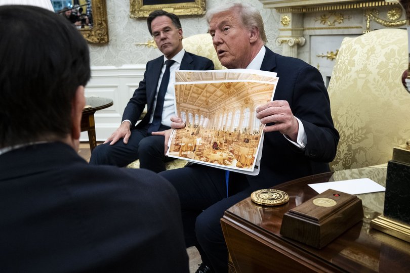 President Donald Trump holds a rendering of the new White House ballroom as meets with NATO Secretary General Mark Rutte in the Oval Office of the White House in Washington, October 22, 2025.
