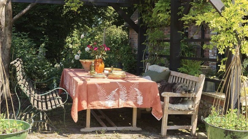 An outdoor patio is surrounded by greenery. Pic: Savills.
