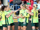 Australia's Courtney Nevin receives congratulations after opening the scoring against Wales. 