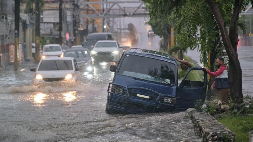 A tropical storm wreaking havoc in the Dominican Republic and Haiti is intensifying. (AP PHOTO)
