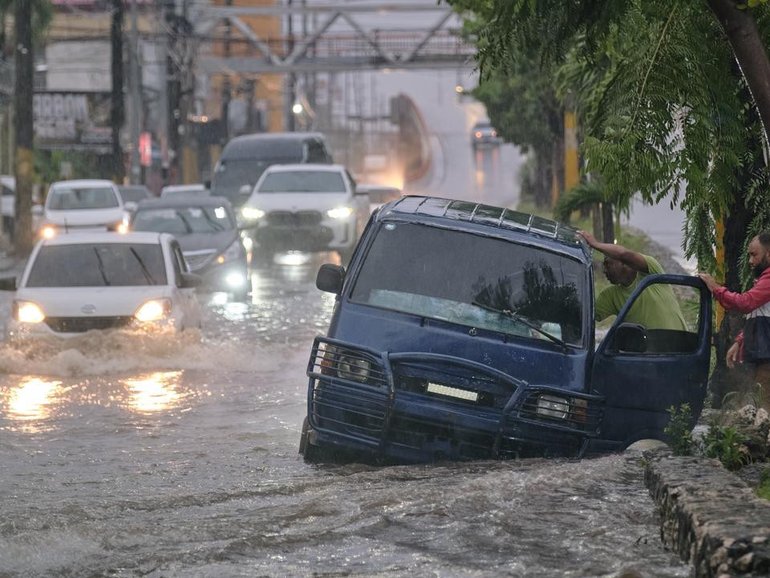 A tropical storm wreaking havoc in the Dominican Republic and Haiti is intensifying. (AP PHOTO)