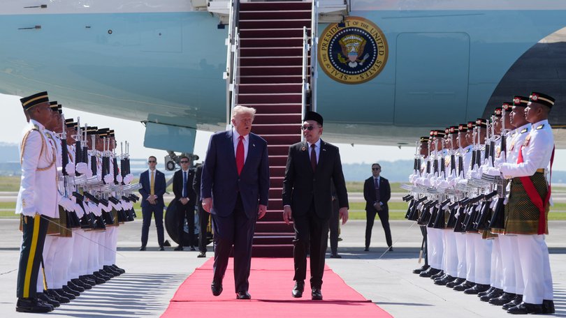 US President Donald Trump walks with Malaysia's Prime Minister Anwar Ibrahim as he arrives at Kuala Lumpur, Malaysia.