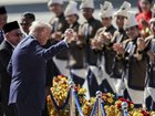 US President Donald Trump (C) joins performers for a dance during the welcome ceremony next to Malaysia's Prime Minister Anwar Ibrahim (L) as he arrives on Air Force One at Kuala Lumpur International Airport in Kuala Lumpur on October 26, 2025.