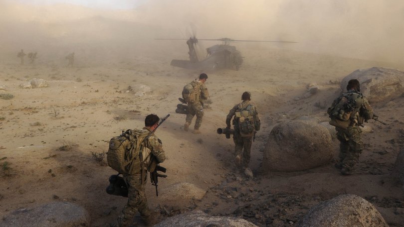 Australian Army soldiers from Special Operations Task Group prepare to board a US Army Black Hawk helicopter after a 'shura' (town meeting) in Sha Wali Kot.