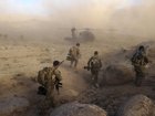 Australian Army soldiers from Special Operations Task Group prepare to board a US Army Black Hawk helicopter after a 'shura' (town meeting) in Sha Wali Kot.