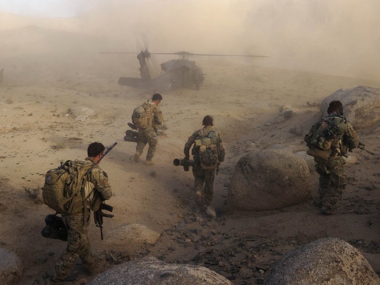 Australian Army soldiers from Special Operations Task Group prepare to board a US Army Black Hawk helicopter after a 'shura' (town meeting) in Sha Wali Kot.