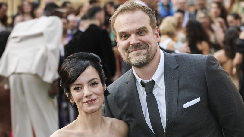 David Harbour, right, and Lily Allen pose for photographers upon arrival at the Olivier Awards in London, Sunday, April 10, 2022.
