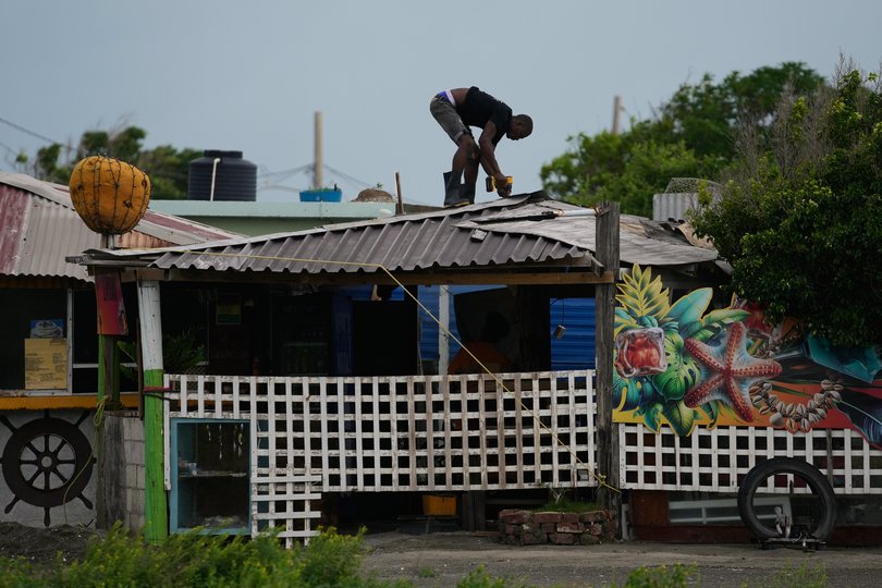 A man fortifies a roof ahead of the forecast arrival of Hurricane Melissa in Kingston, Jamaica.