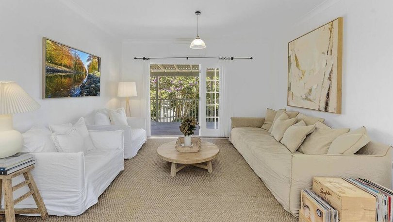 The living room leads out onto a balcony.
